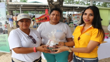 Mrs Ramirez receiving second prize on behalf of her husband Abel Ramirez from OW. The second prize was courtesy of Belizean Home made Jellies from the Cayo Dist.